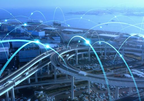 image of a city with laser lights around it
