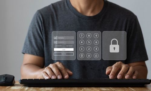 man at keyboard doing multi factor logging in