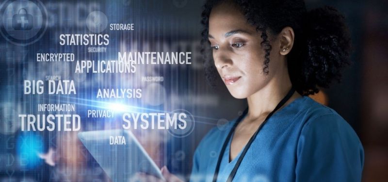 nurse looking at tablet with cyber security jargon hovering above it